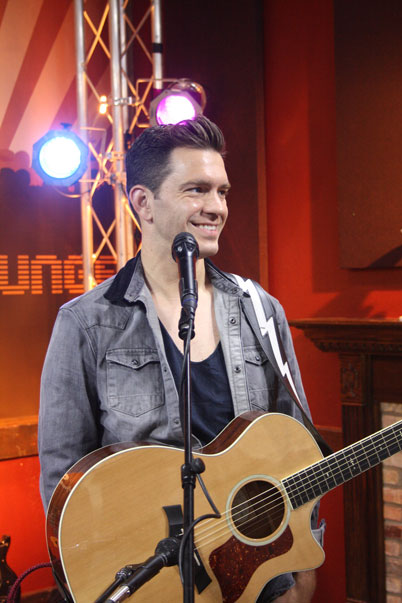 Andy Grammer talking with the cast